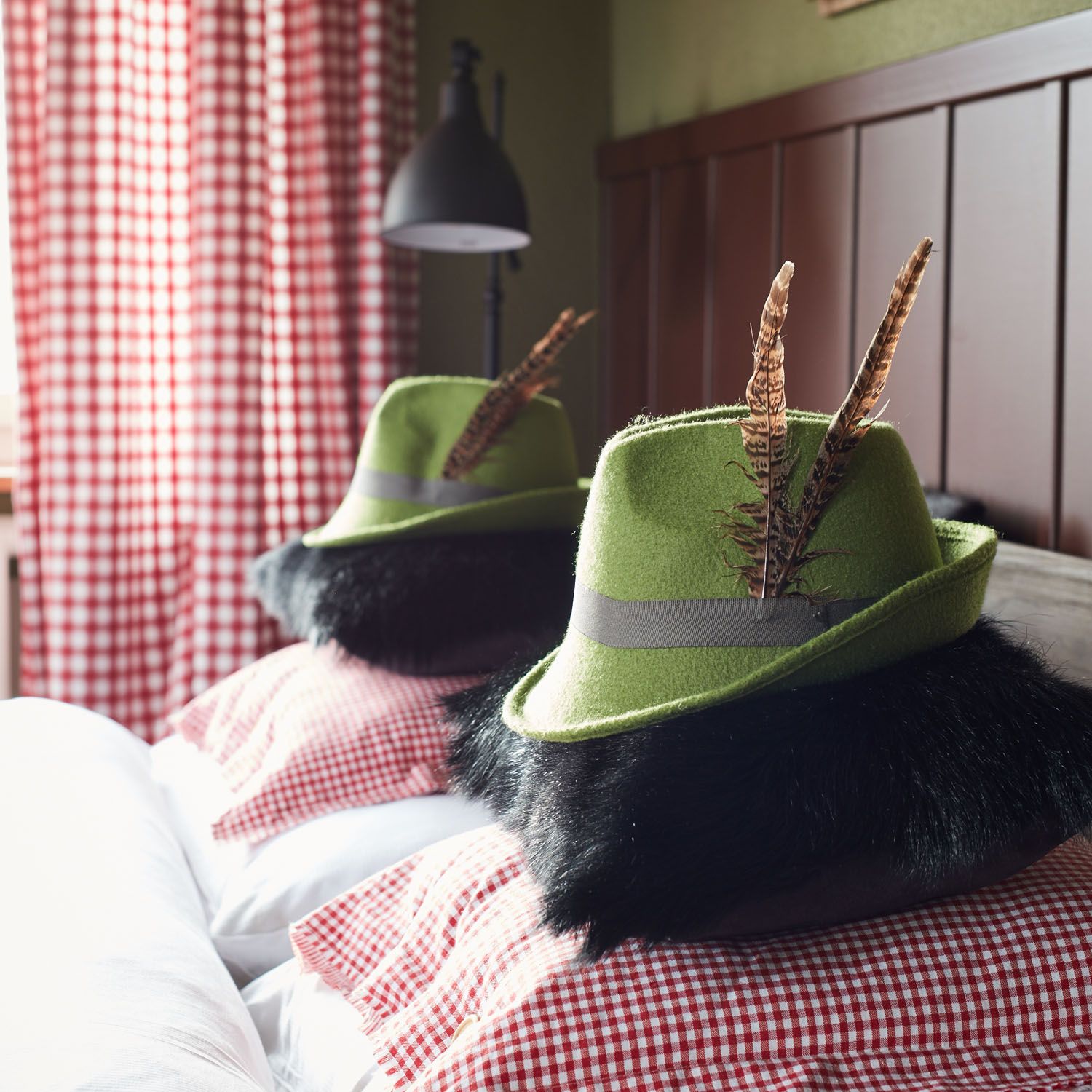 Two Alpine hats on checked bed linen